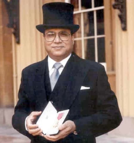 Sir Anwar Pervez holding OBE.